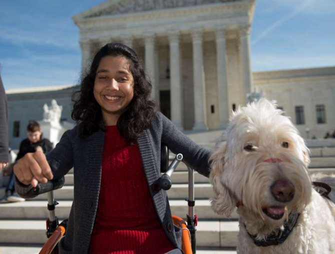 Young girl with her service dog on the steps of the United State Supreme Court